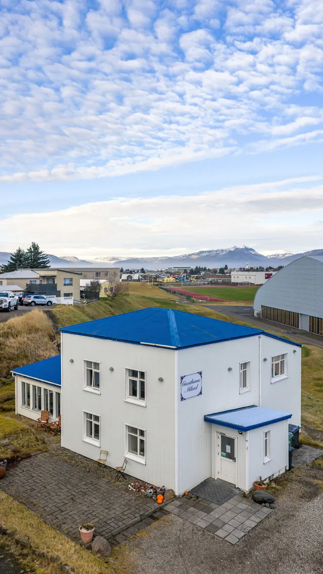 The guesthouse from above, with the fjord beyond