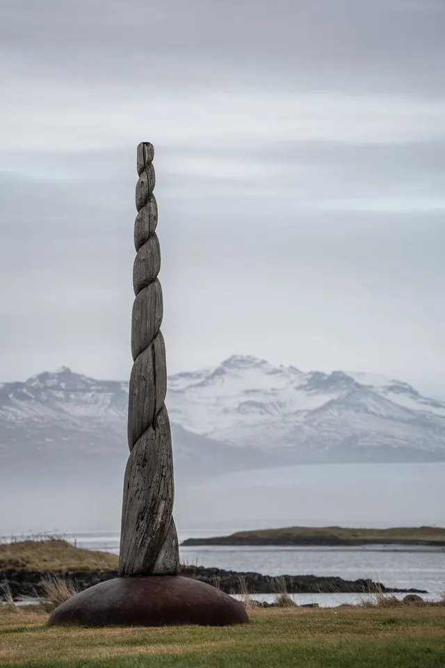 A sculpture on the shore at dusk