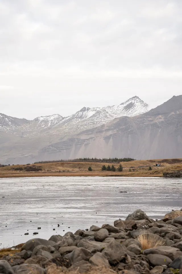 Snow on the mountains across the water