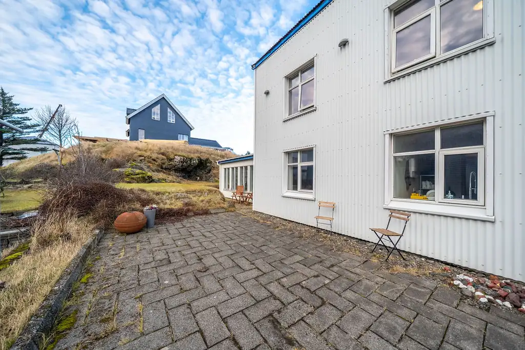 The side of the guesthouse and its paved courtyard