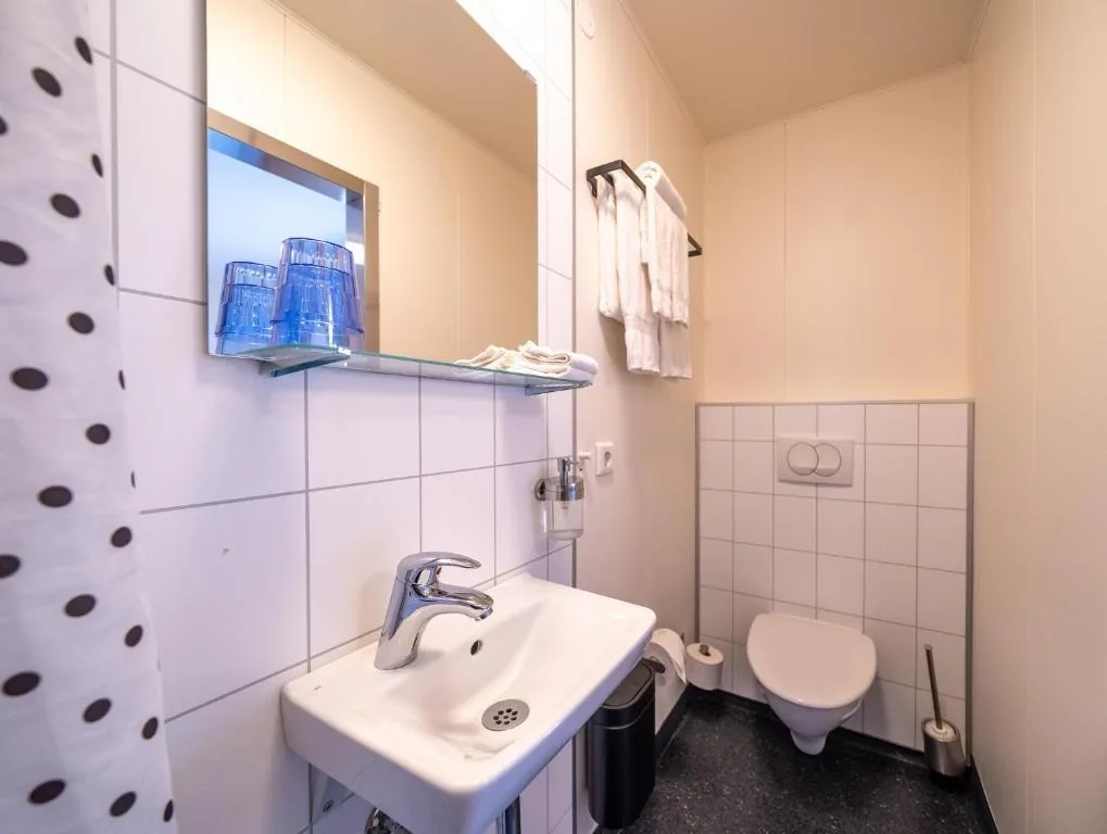 Private bathroom with a washbasin and mirror