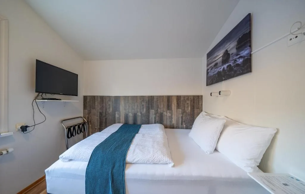 Economy Room with reading lamps above the bed