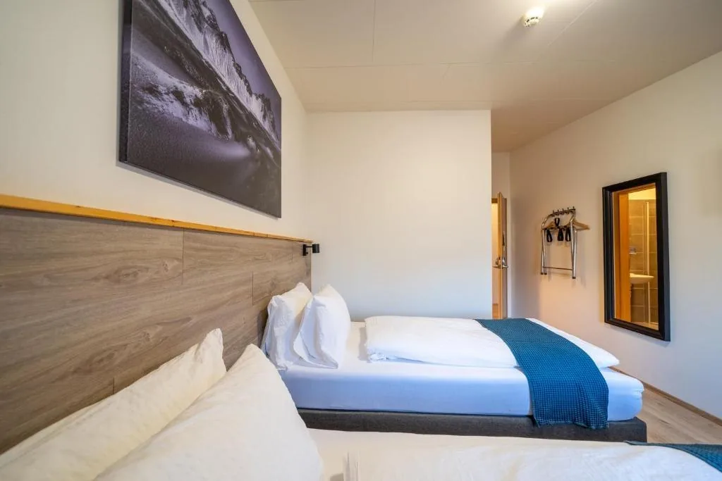 Twin beds made up with teal runners